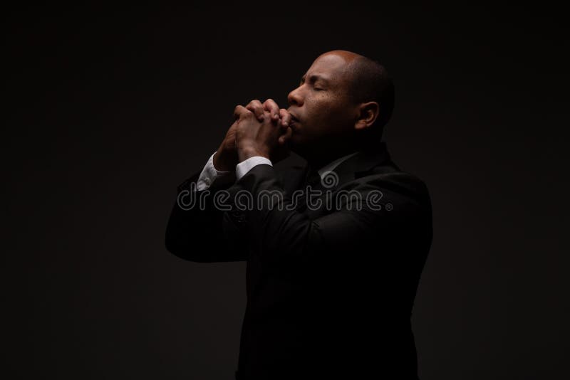 African American Christian Man Praying and Seeking Guidance from God