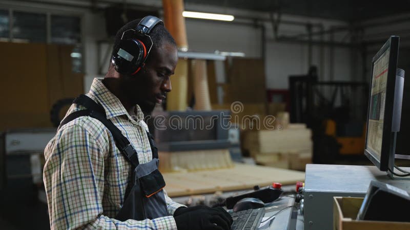 African American CNC Operator Programmes Machine Cut Machine stock footage