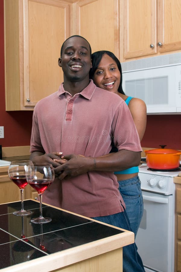 African American Couple Hugging in the Kitchen