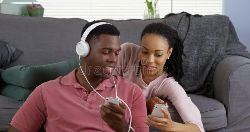 African American Couple Listen To Music And Browse Internet With Smartphones Stock Image Image