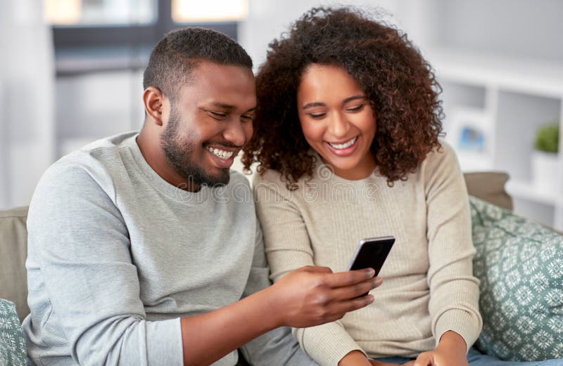 African American Couple with Smartphone at Home Stock Image - Image of ...