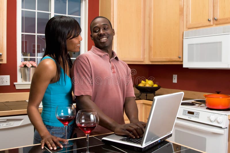African American Couple Using Laptop in Kitchen