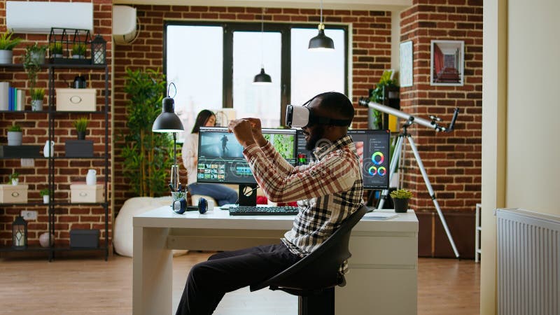 African american editor uses virtual reality glasses to do color grading stock photo