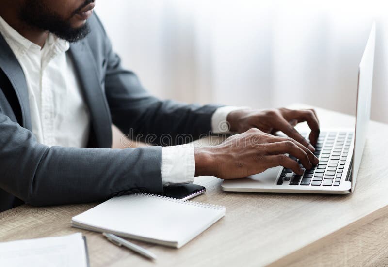 African American Employee Working On Laptop In Modern Office Stock