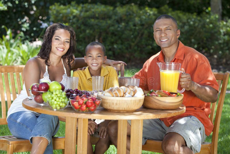 African American Family Eating Food Outside stock image African American Family Eating Food Outside stock image