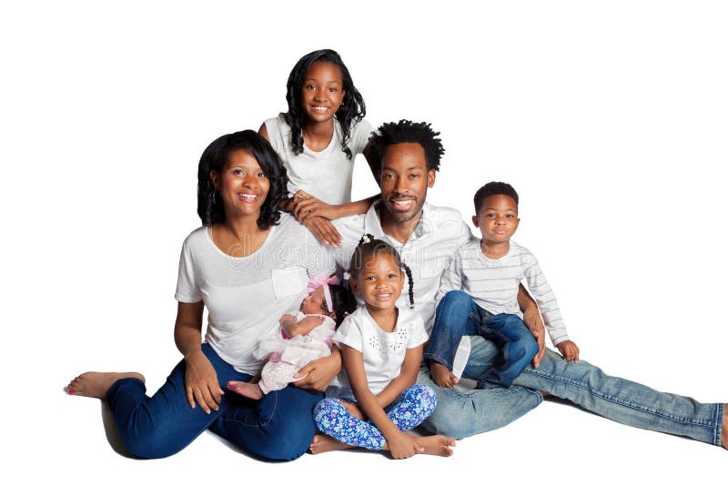 A beautiful African American family with four, young kids, pose for a portrait on a white backdrop. Has a clipping path containing the people and shadows. A beautiful African American family with four, young kids, pose for a portrait on a white backdrop. Has a clipping path containing the people and shadows.