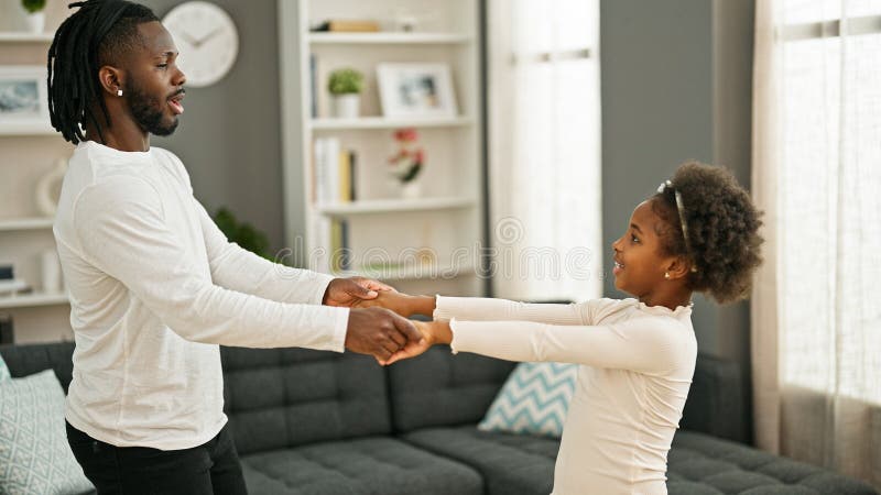 African american father and daughter smiling confident dancing at home. Father daughter listening stock images, royalty-free photos and pictures