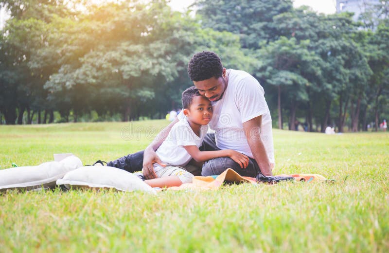 African american father and son having a picnic in the park, Happiness family concepts.