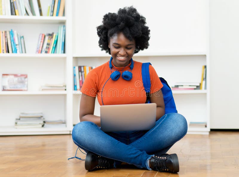 African american female student learning online at computer with other students indoors at home. Computer editing stock images, royalty-free photos and pictures