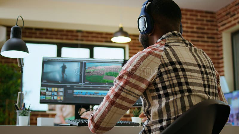 African american filmmaker editing a video shoot in post production stock photography