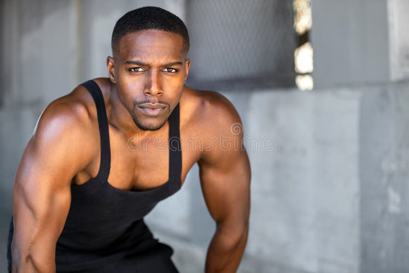 African american fitness and sport head shot portrait in tank top in gritty urban concrete background with copy space stock photos African american fitness and sport head shot portrait in tank top in gritty urban concrete background with copy space stock photos