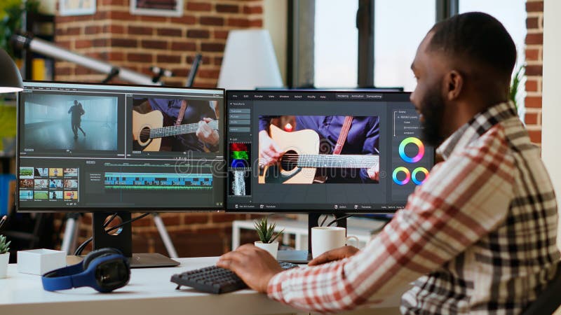 African american freelancer editing a background video at his home office stock photos