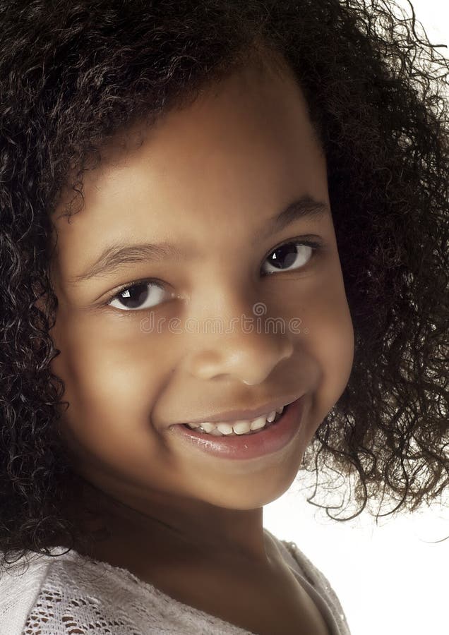 Portrait of happy African American teen girl looking at camera at home,  headshot of smiling black teenager posing indoors, beautiful mixed race  teenage female laughing making picture Stock Photo