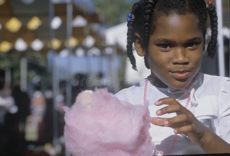 An African-American Girl Eating Cotton Candy, Editorial Photo - Image of  hair, color: 26248586