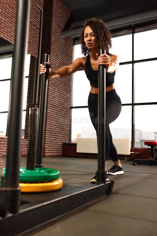 African American Girl Fitness Trainer Pulls a Crossfit Sled Out of the ...