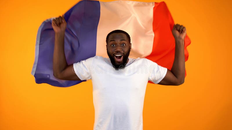 African-American man holding French flag, football fan supporting national team stock photos African-American man holding French flag, football fan supporting national team stock photos