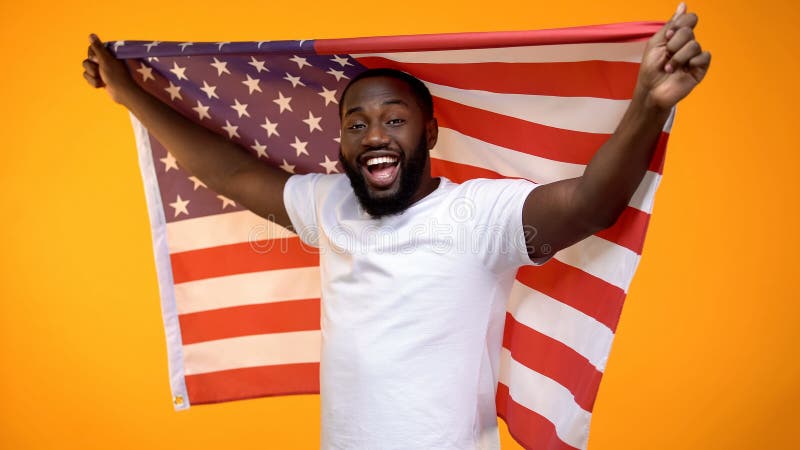 African-American man holding US flag, independence day celebration, holiday