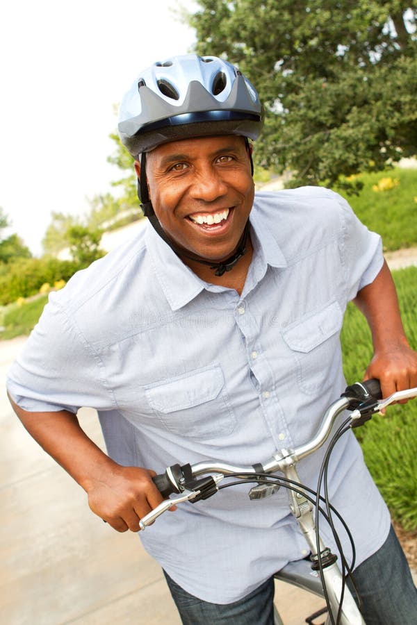 African American Man Riding a Bike. Stock Image - African American Man RiDing Bike Mature African American Man RiDing Bike 99647205