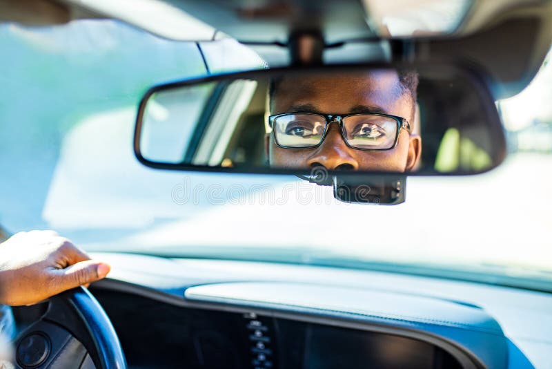 Man Adjusting A Rearview Mirror Stock Photo - Download Image Now