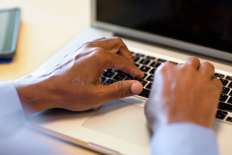 African American man at typing on a computer.