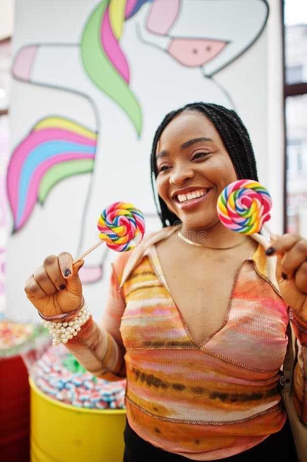 African american Millennium Lady på candy shop med lolipops arkivfoton