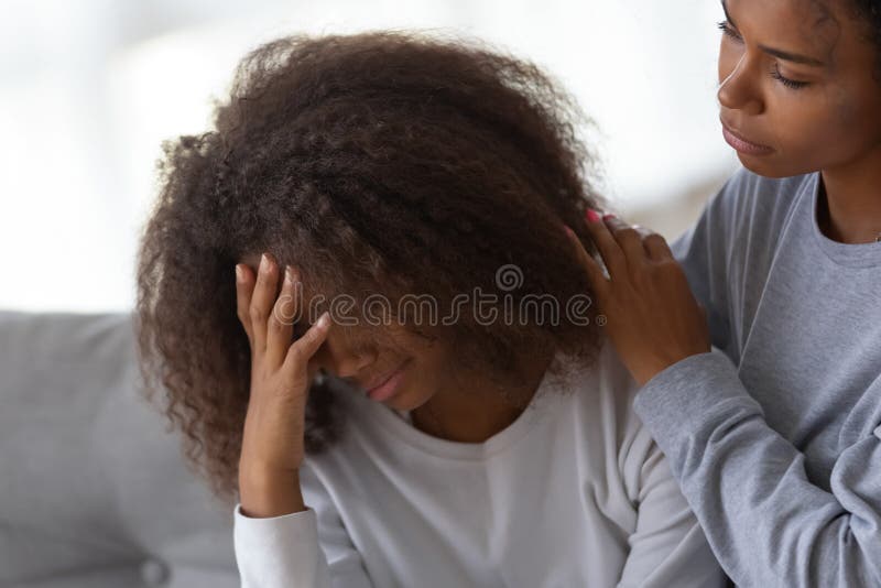 African American mom hug comforting sad teenage daughter