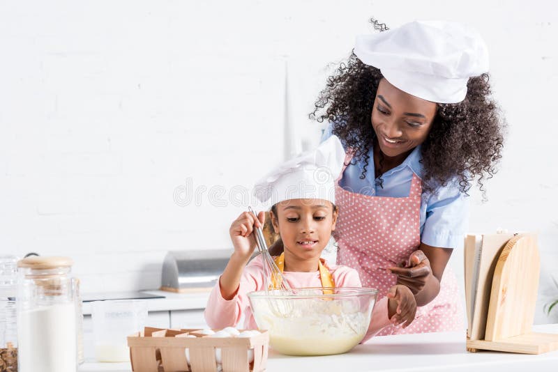 https://thumbs.dreamstime.com/b/african-american-mother-daughter-chef-hats-mixing-dough-kitchen-cookbook-african-american-mother-daughter-127681285.jpg