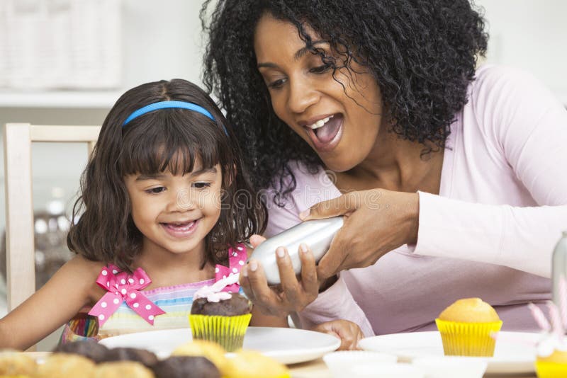 African American Mother Daughter Icing Cakes stock photos African American Mother Daughter Icing Cakes stock photos