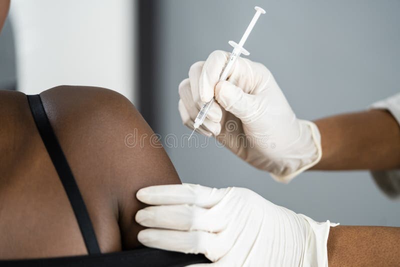 African American Nurse Making Covid-19 Vaccine Injection stock photography