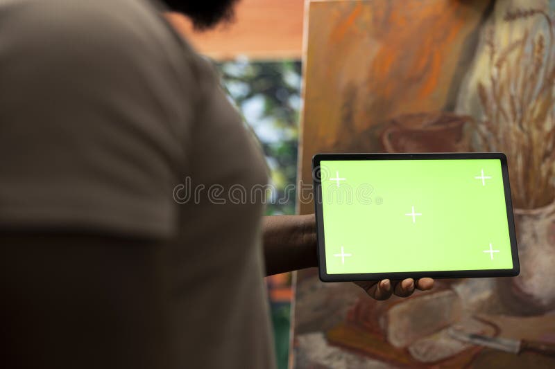 African american painter using a gadget with copy space screen in workshop stock photos