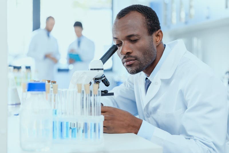 african-american-scientist-white-coat-working-microscope-laboratory-researcher-concept-94008432.jpg