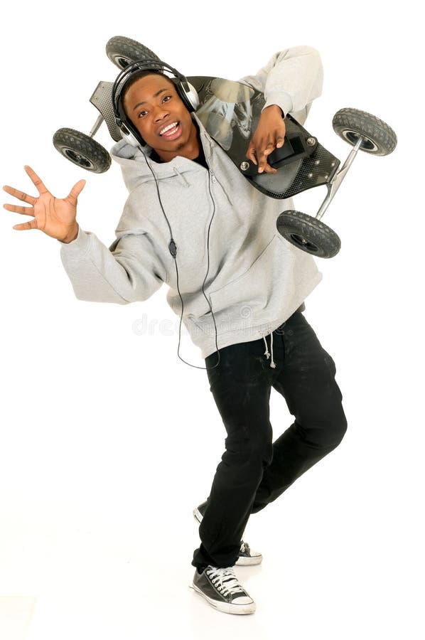 Handsome youngster, black African American teenager with mountain-board and headset, hip hop urban culture. Studio white background. Handsome youngster, black African American teenager with mountain-board and headset, hip hop urban culture. Studio white background