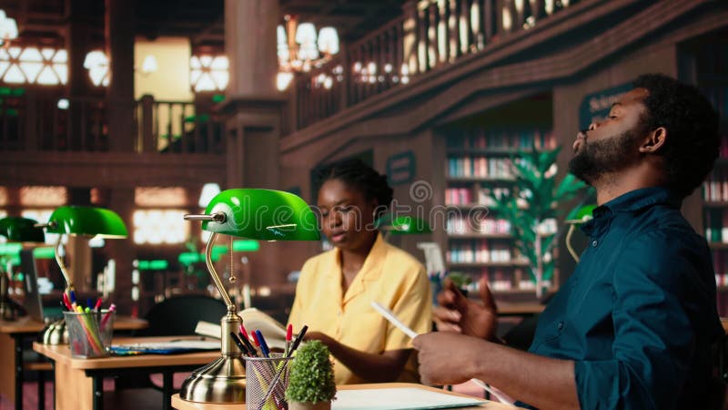 African american students learning a foreign language at the university library stock video footage