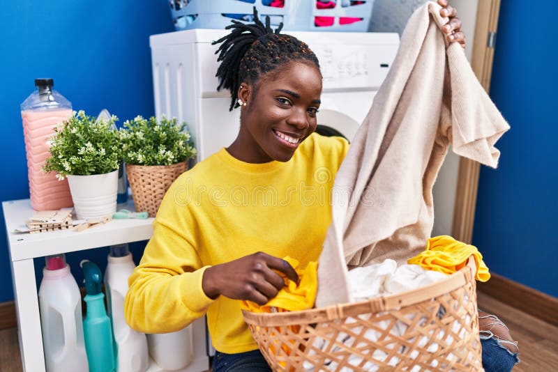 African American Woman Holding Basket with Clothes at Laundry Room ...