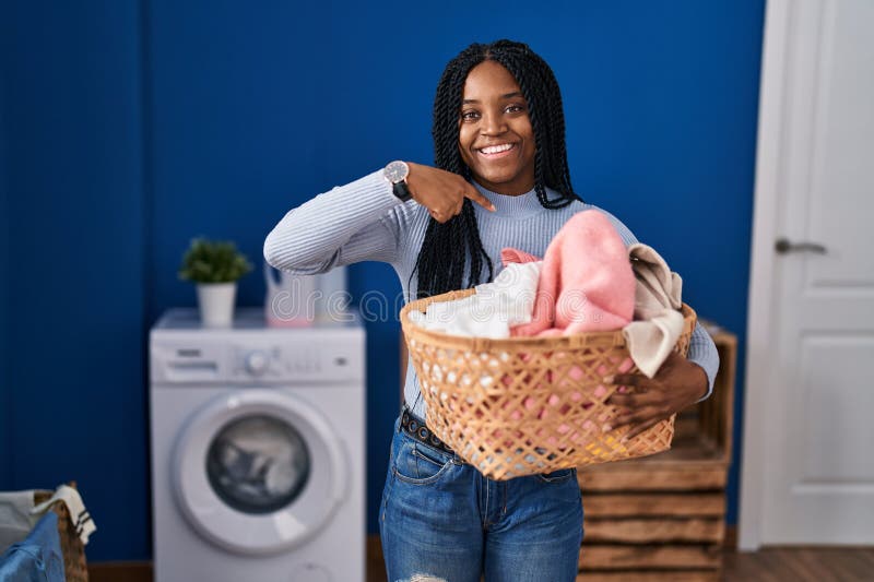 African American Woman Holding Laundry Basket Pointing Finger To One ...