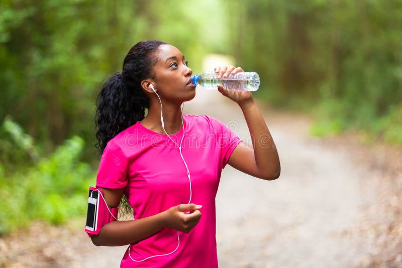 African american woman jogger drinking water - Fitness, people