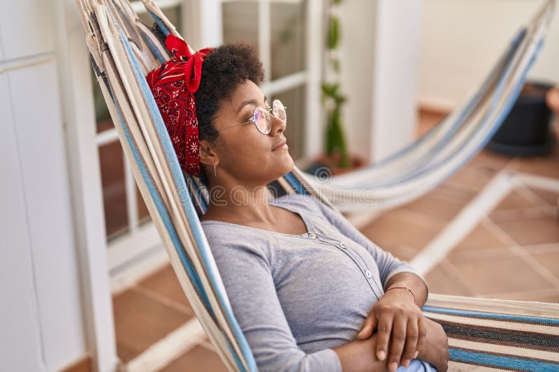 African American Woman Lying on Hammock Sleeping at Home Terrace Stock ...