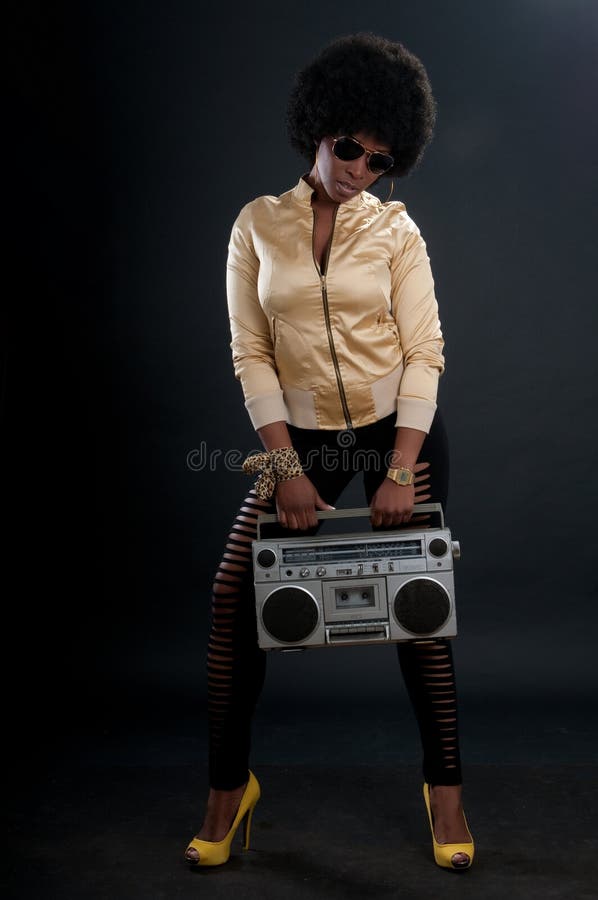 African American woman with retro look and a cassette tape player