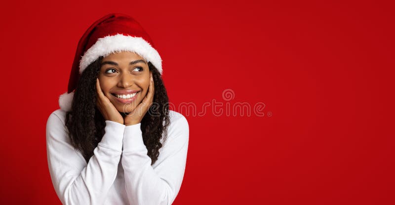 African american woman in Santa hat looking at copy space