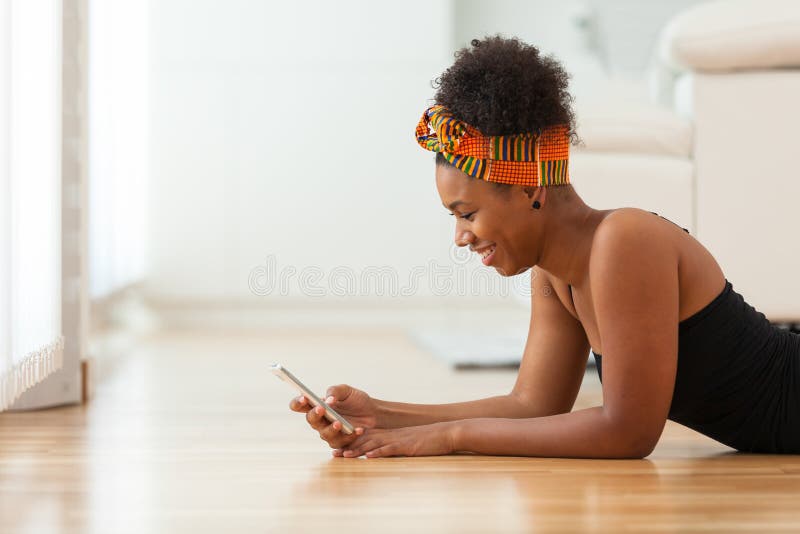 African American woman sending a text message on a mobile phone