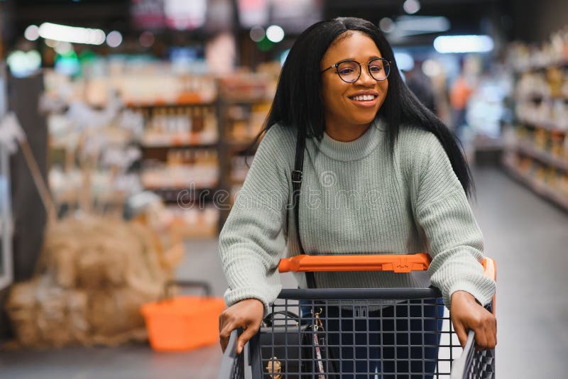 African American Woman with Shopping Cart Trolley in the Supermarket ...