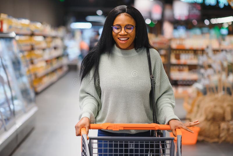 African American Woman with Shopping Cart Trolley in the Supermarket ...