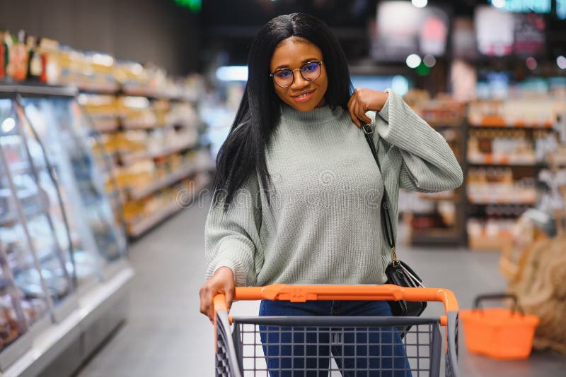 African American Woman with Shopping Cart Trolley in the Supermarket ...