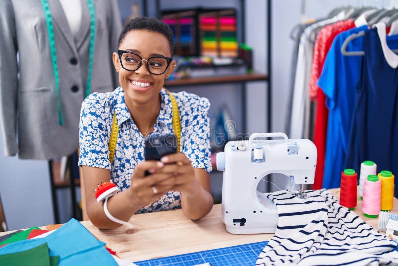 African American Woman Tailor Smiling Confident Using Smartphone at ...