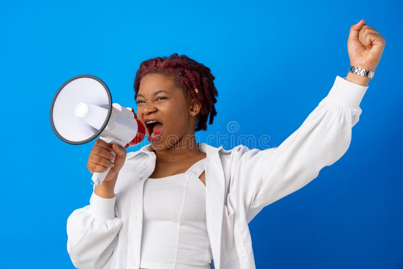 African american woman using megaphone against blue background, close up