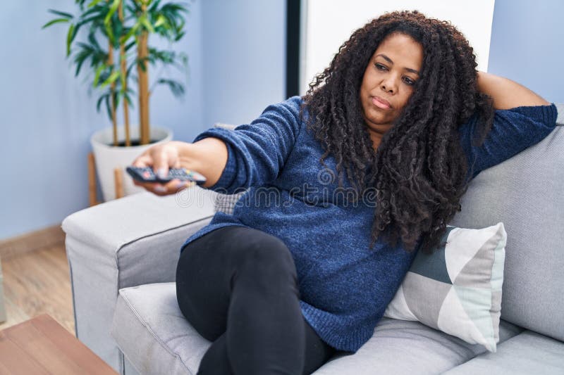 African American Woman Watching Tv Lying on Sofa with Boring Expression ...