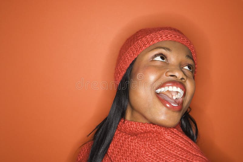 African-American woman wearing orange scarf and hat. stock image African-American woman wearing orange scarf and hat. stock image
