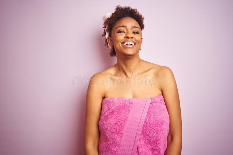 African american woman wearing shower towel after bath over pink isolated background with a happy and cool smile on face