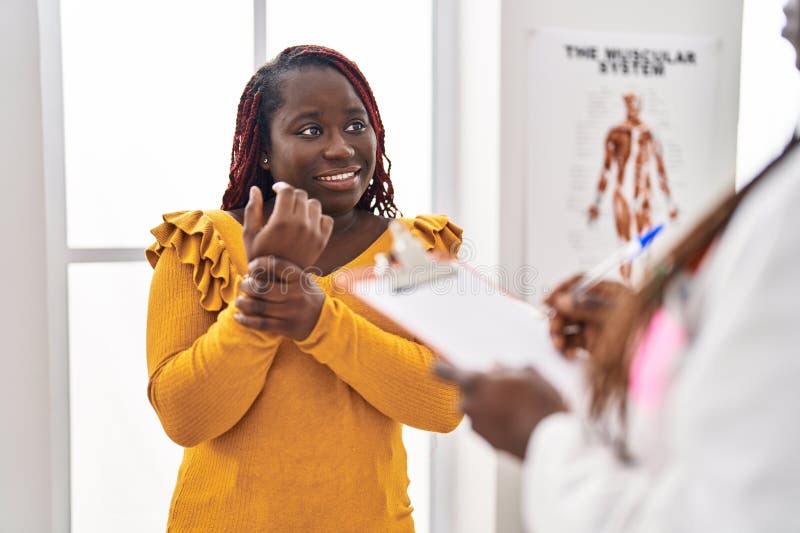 African American Women Doctor and Patient Having Consultation at Clinic ...