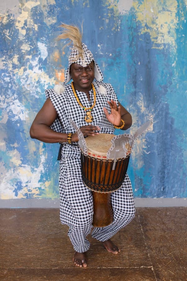 African Artist in Traditional Clothes Playing Djembe Drum Stock Photo ...
